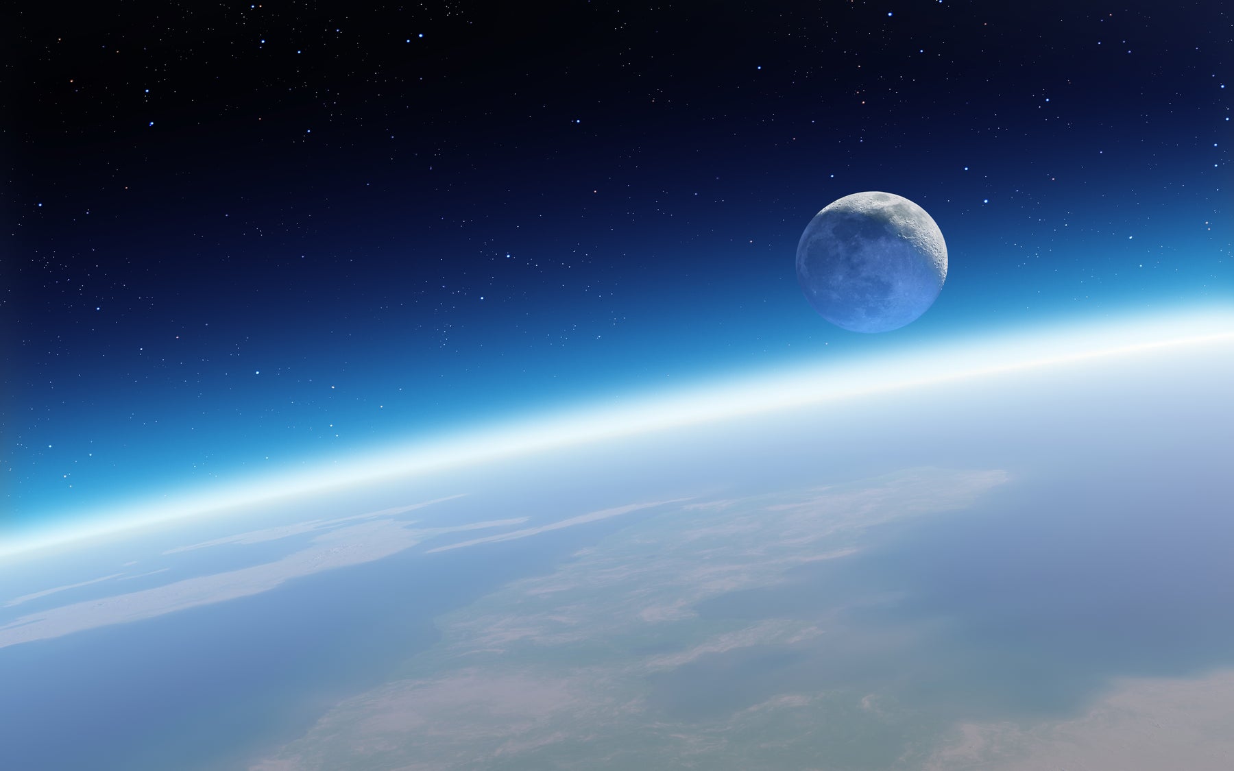 The full moon is rising over a arc portion of the earth with space and the stars in the background. Many shades of blue accentuating the vast universe beyond. A Satellite view on the moon rising above the stratosphere.